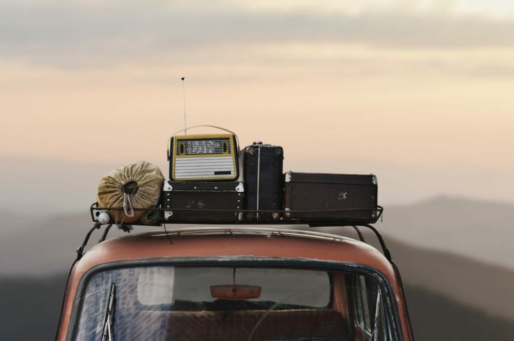 traveler car with roof rack and things in retro style on mountai